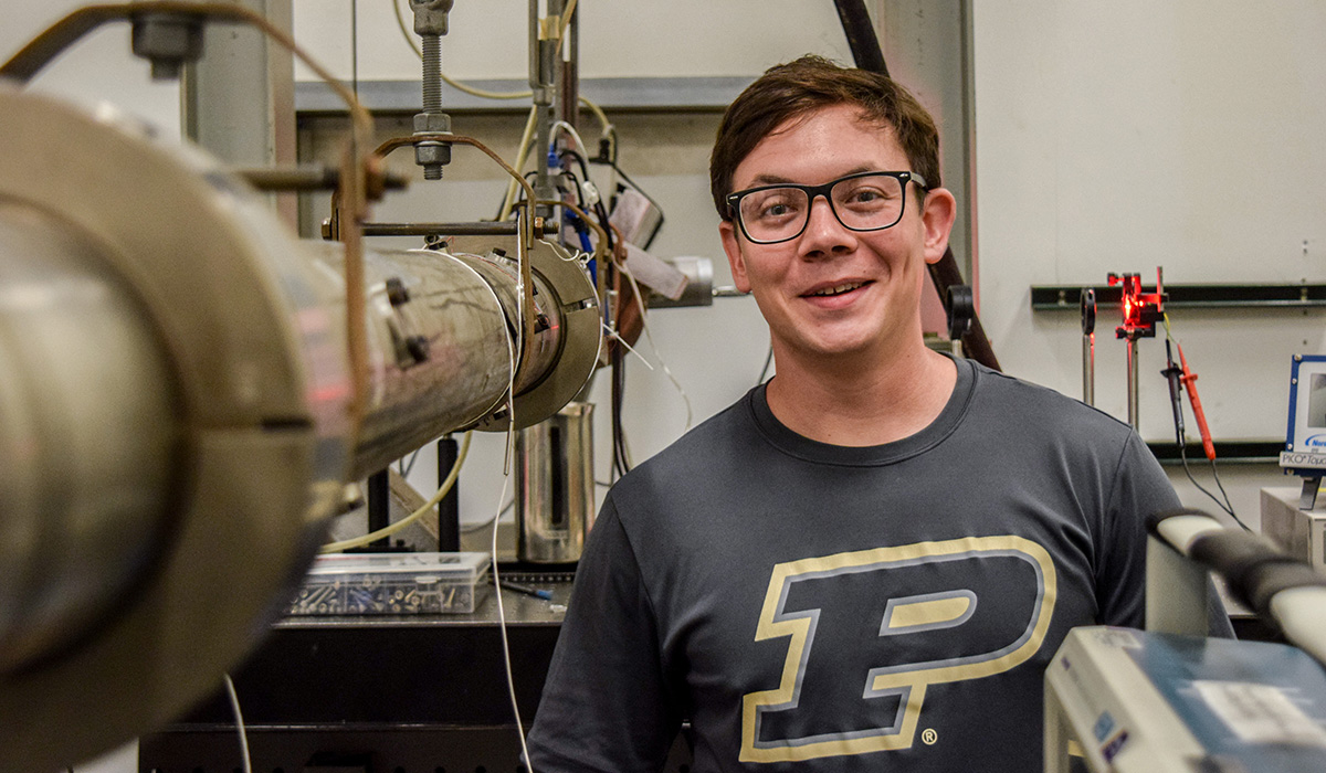 AAE student Joe Lavalley standing next to a shock tunnel