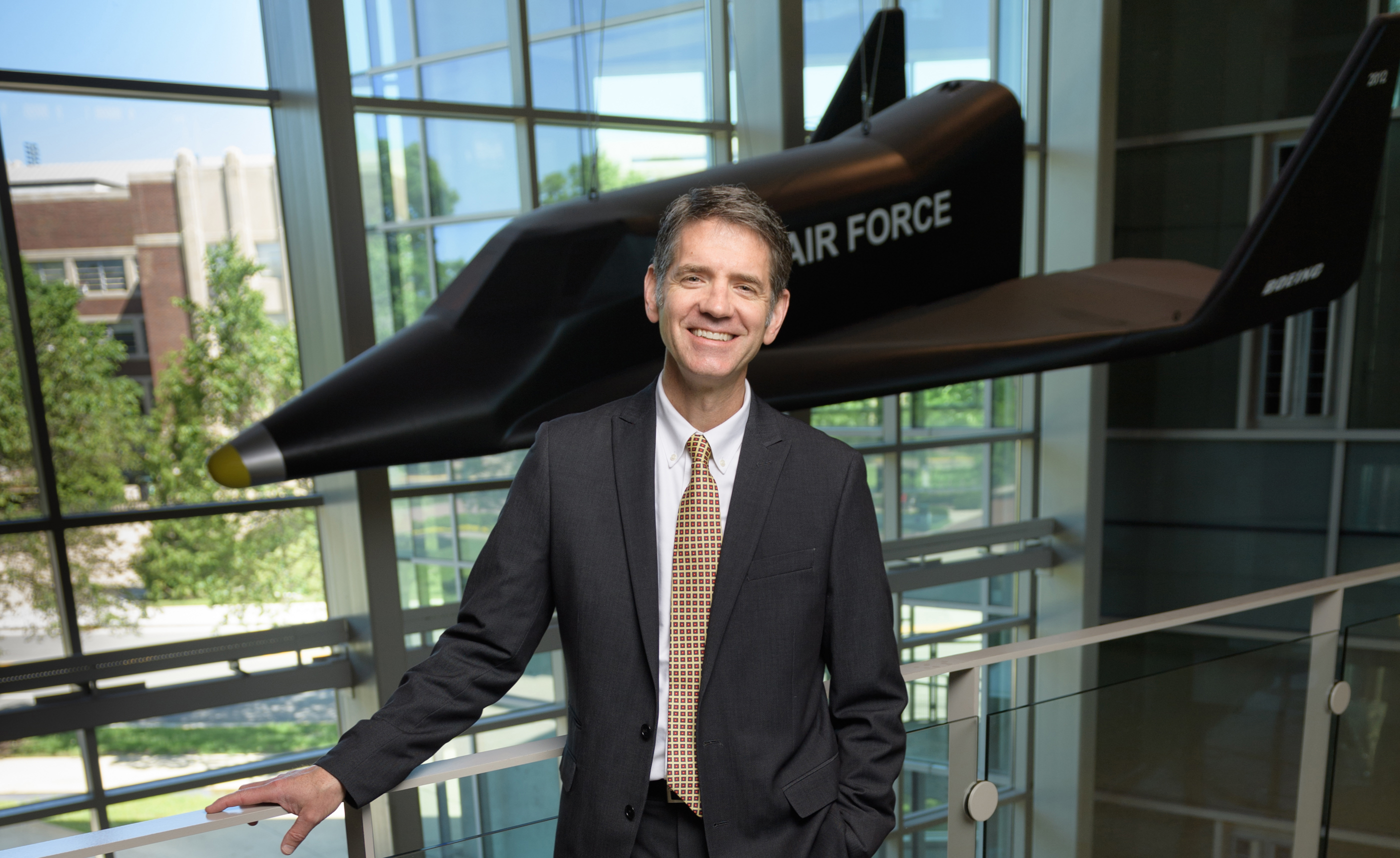 William Crossley in Armstrong Hall with the Air Force plane template behind him