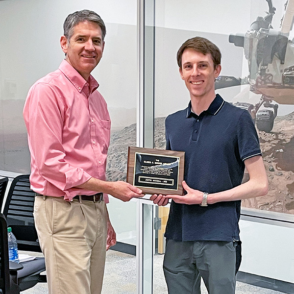 Justin Mansell receiving award from Bill Crossley