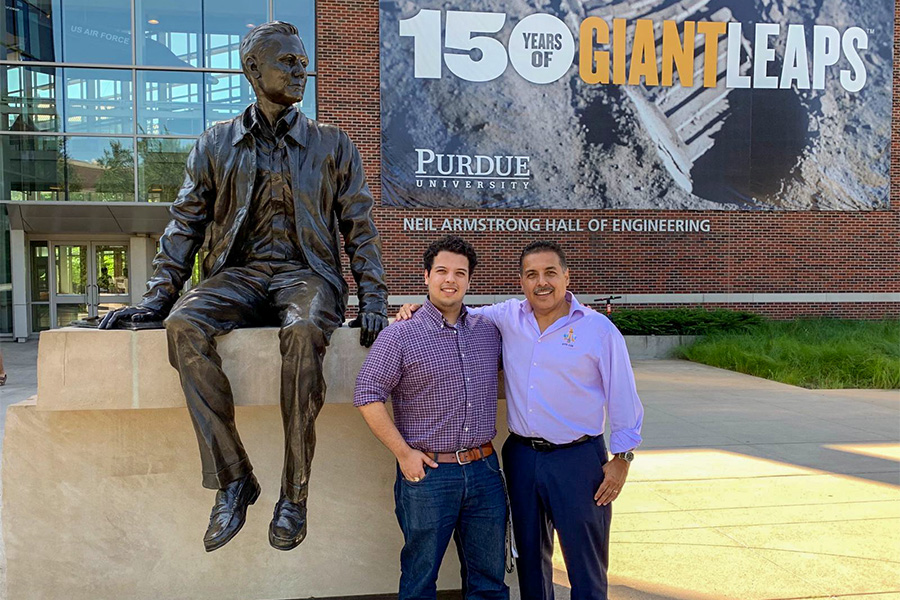 Julio Hernndez and his astronaut father Jos standing next to the Neil Armstrong statue at Purdue