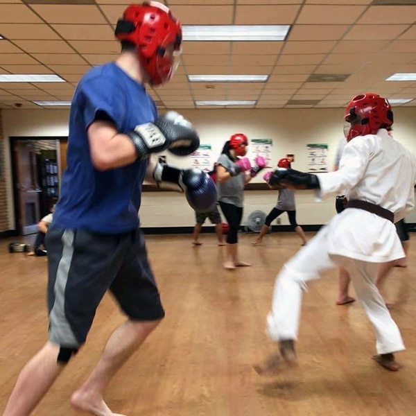 Kamwana Mwara sparring at a karate kickboxing dojo