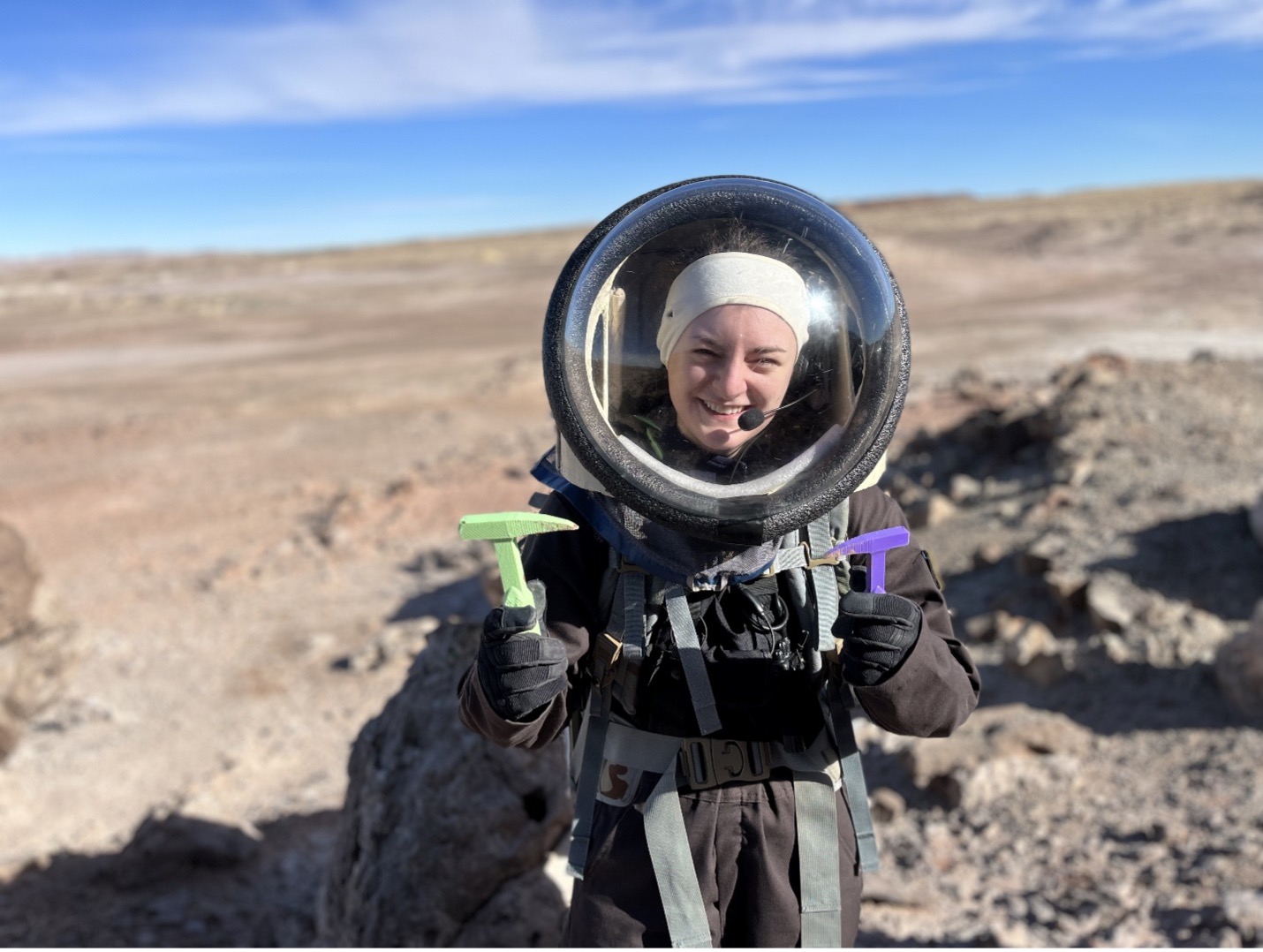Megan holding two rock hammers that were 3D-printed