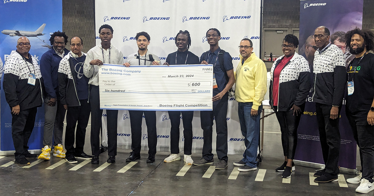 The Boiler Wings team standing with a large novelty check for $600