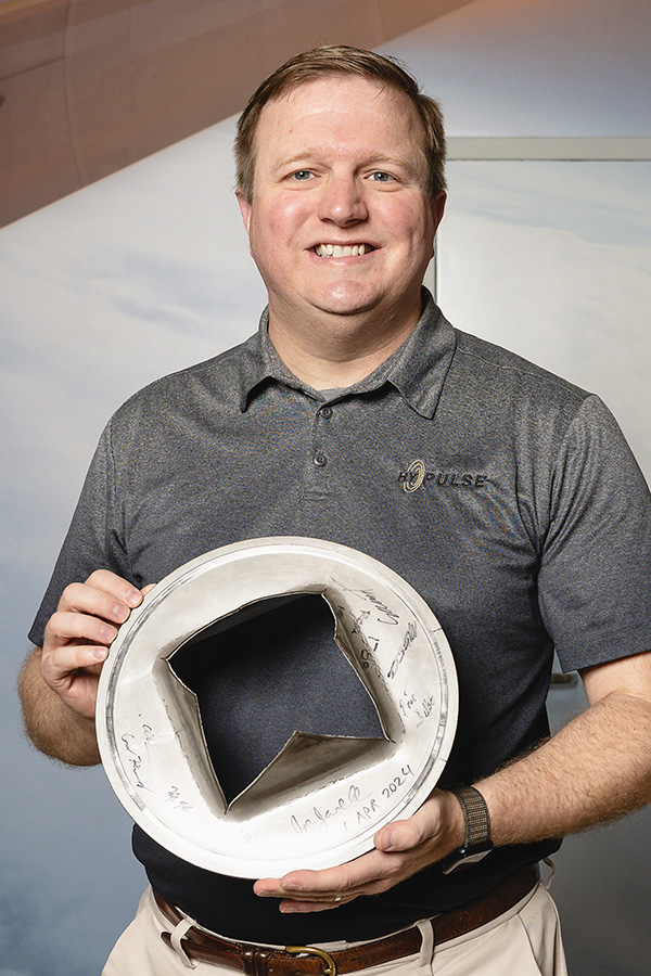 HYPULSE director Joe Jewell, seen here with the burst metal disc that initiates the shock tunnel test, is also the John Bogdanoff Associate Professor of Aeronautics and Astronautics at Purdue.