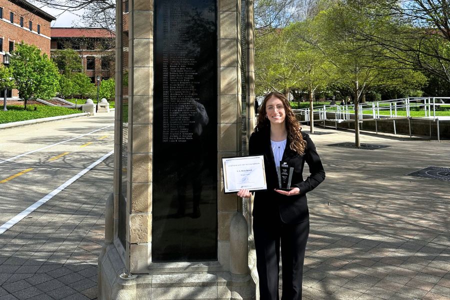 Abby Frank next to the award marker at the Purdue Engineering Mall.