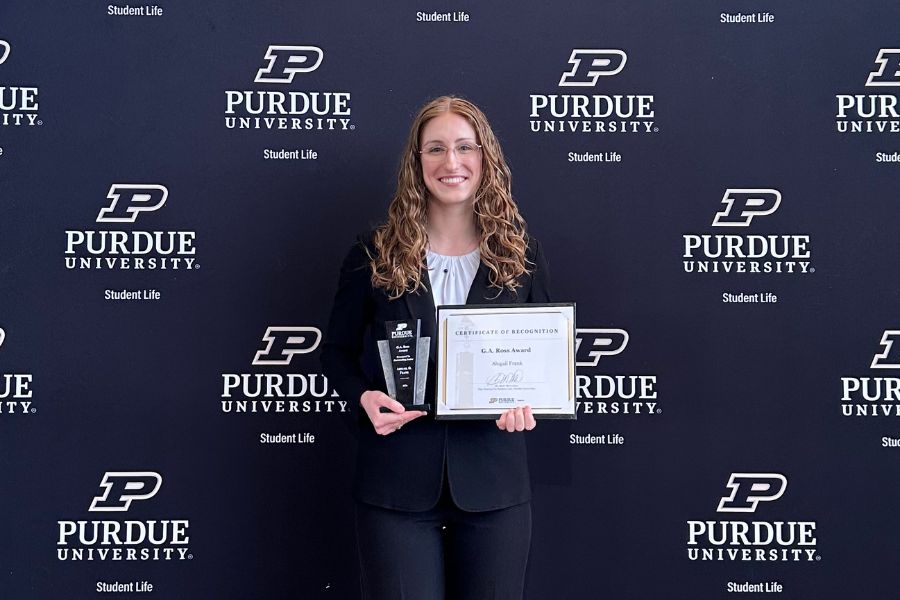 Abby Frank posing with her G.A. Ross Award.