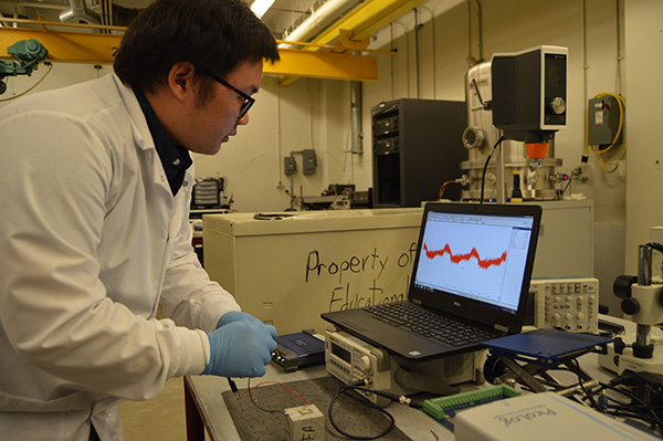 Civil Engineering PhD student Yen-Fang Su uses vibrations to test the strength of a concrete sample. The team plans to take its research into the field within a year.