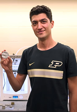 PhD candidate Mohamadreza "Reza" Moini demonstrates the latest 3D-printed model, created in Hampton Hall.