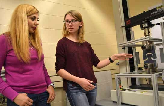 Post-doctoral researcher Maryam Hosseini and undergraduate Molly Cooper test the strength of the beetle-inspired material.