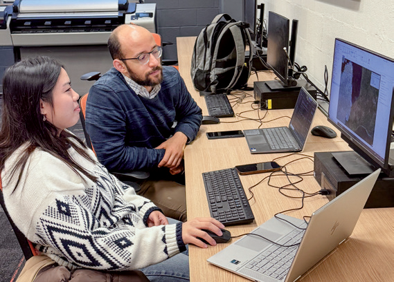 Undergraduate researcher Sophia Ung and graduate research assistant Hazem Abdelhady examine satellite imagery data.