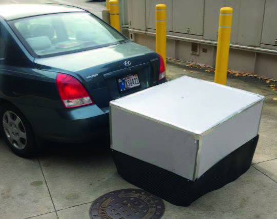 The camera is housed in a case designed by students and attached to the back of a vehicle.
