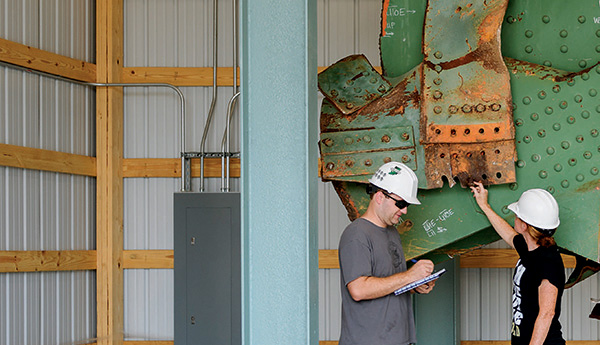 Grad students inspecting bridge remnant at the CAI