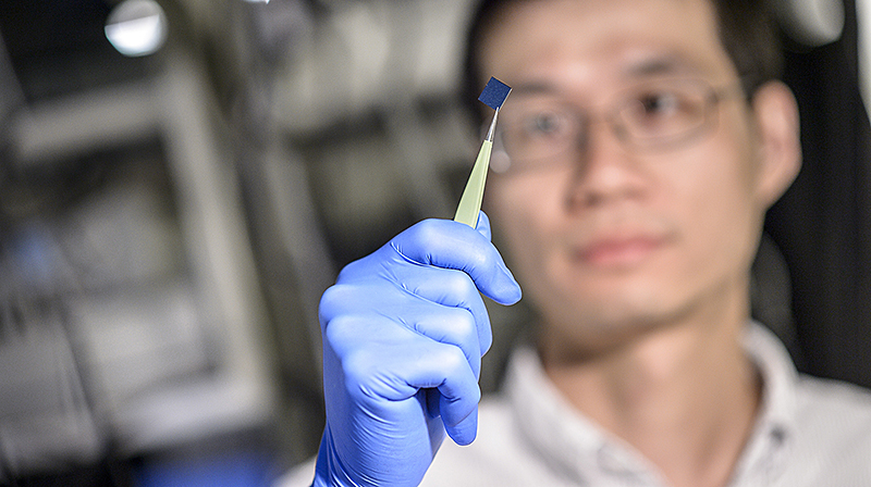 man holding microchip
