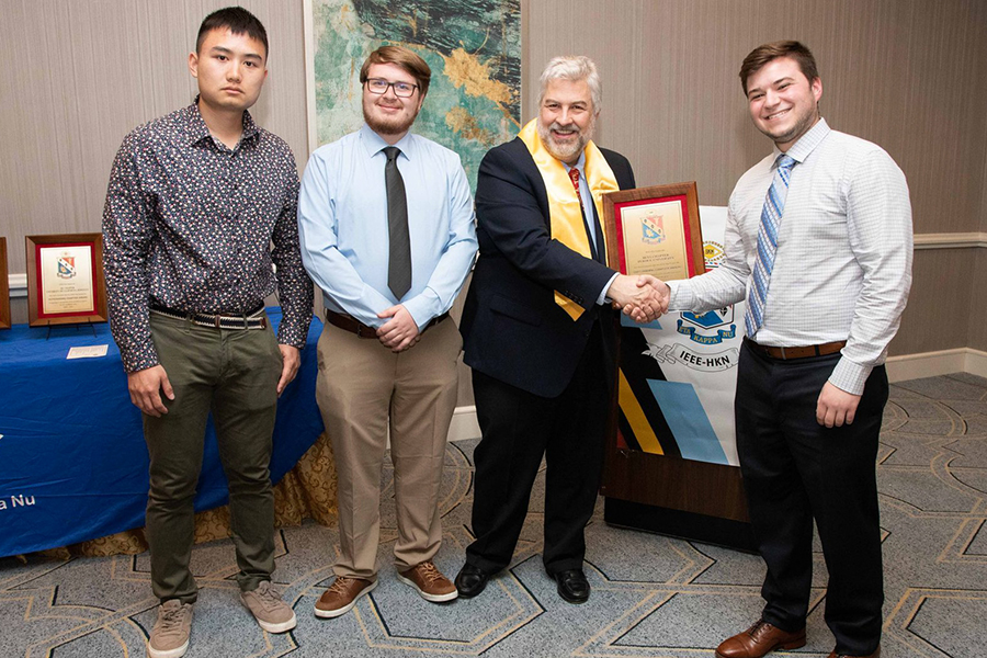 members of hkn receiving their chapter award