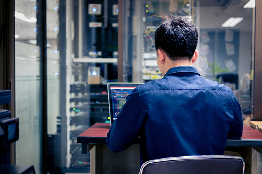 man sitting at computer
