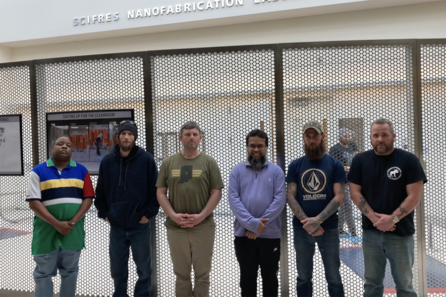 Muhammad Hussain and a group of verterans stand for a photo in the Birck Nanotechnology Center.