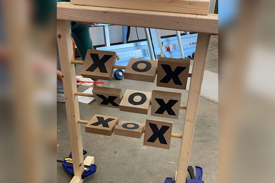 A freestanding, wooden, tic-tac-toe game