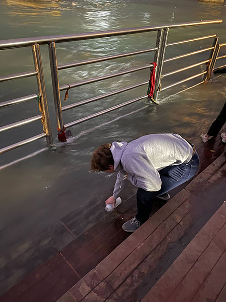 student collecting a water sample