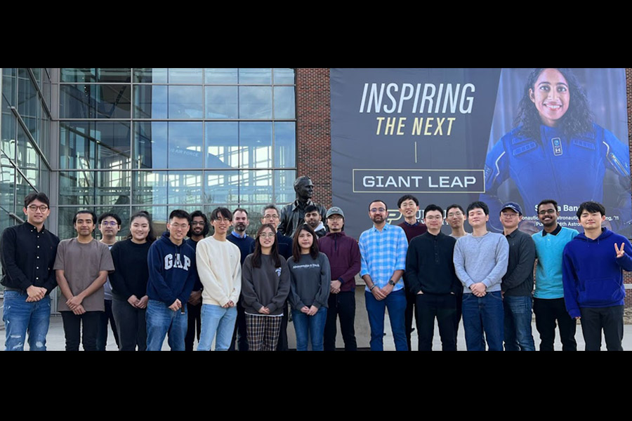 Group of people standing in front of a building.