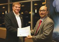 IE Head Abhi Deshmukh presents Associate Professor Steve Landry with the James H. Greene Outstanding Graduate Educator Award