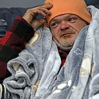 Brett Saint rests inside a Gallery Furniture store which opened as a shelter for those in need of food, water and heat Wednesday, Feb. 17, 2021, in Houston. Millions in Texas still had no power after a historic snowfall and single-digit temperatures created a surge of demand for electricity to warm up homes unaccustomed to such extreme lows, buckling the state's power grid and causing widespread blackouts. (AP Photo/David J. Phillip)
