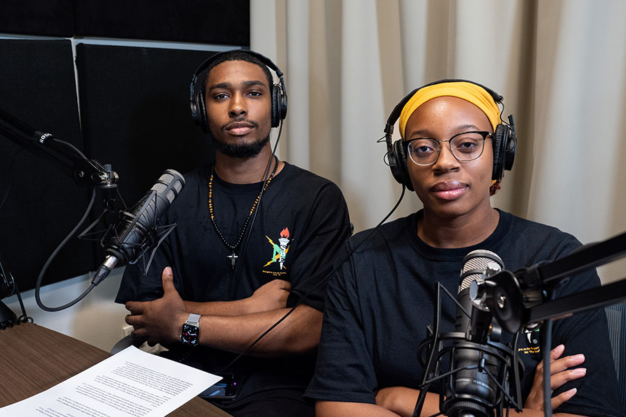 Underwood and Maxey with headphones and in front of microphones