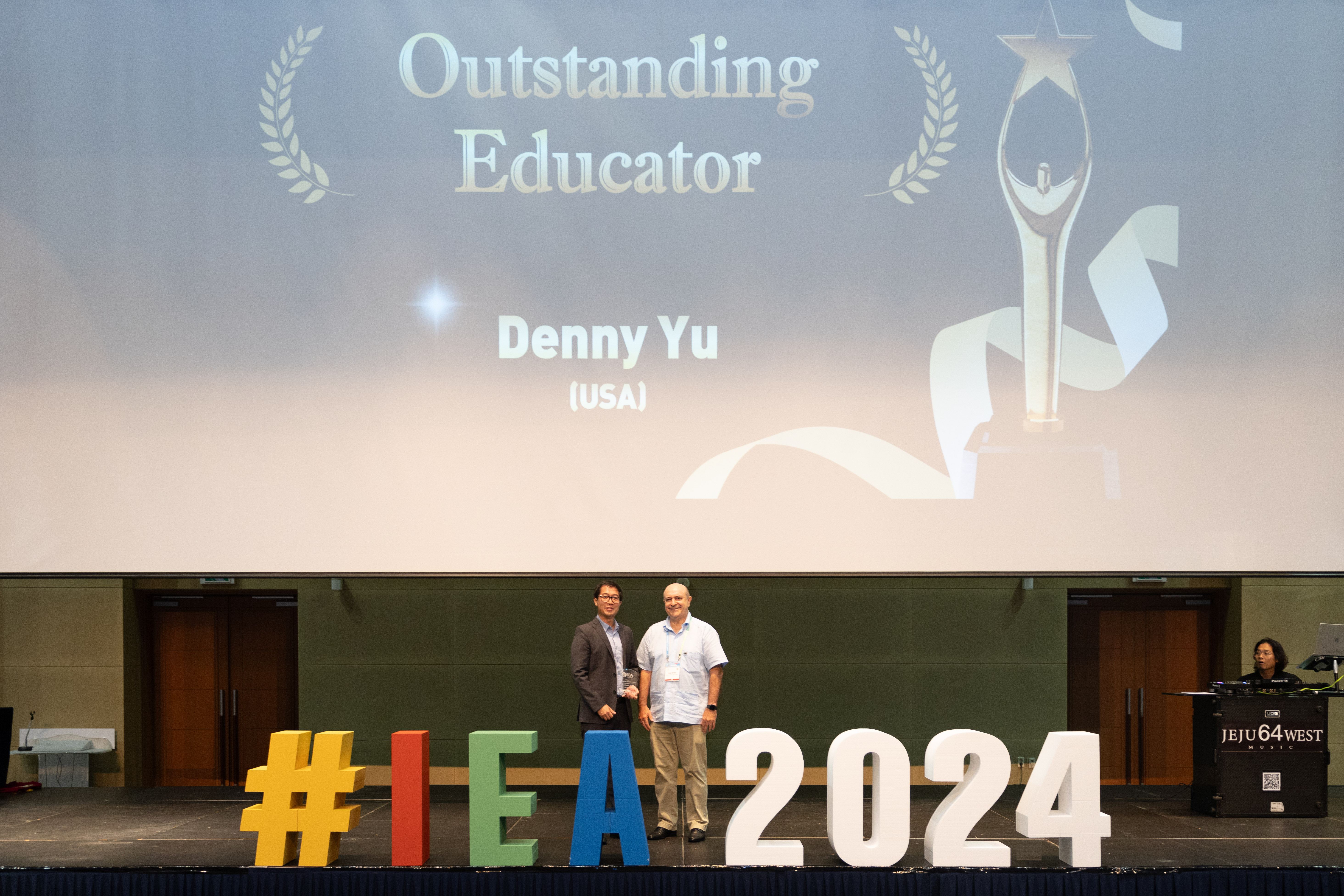 Assistant Professor Denny Yu accepting his most recent award