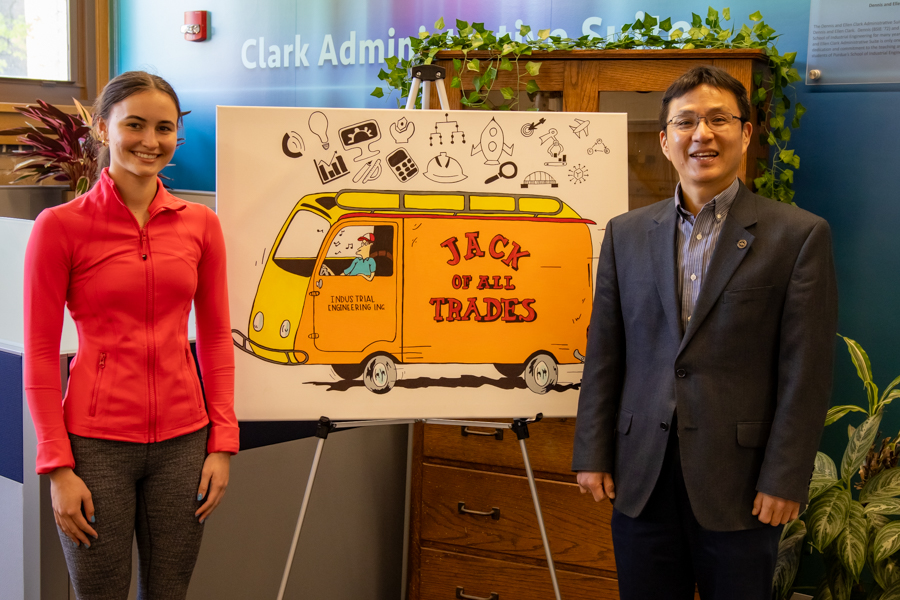 Gigi Winter poses next to her winning painting with Dr. Son