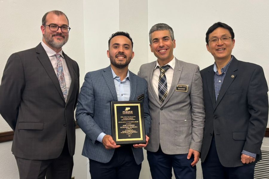 Jose Alfredo Ocegueda poses with award and faculty members.
