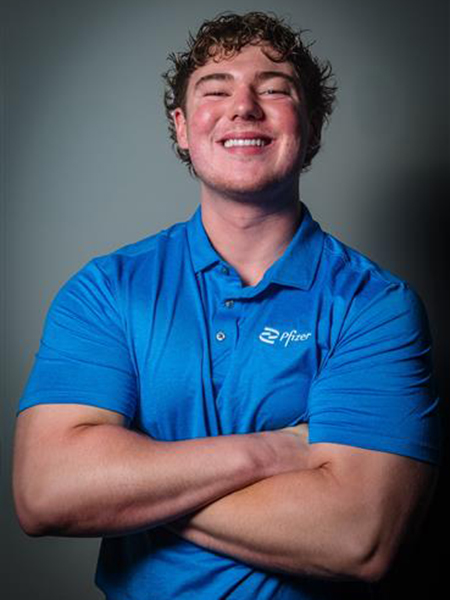 Student, smiling, with dark hair wearing a blue shirt