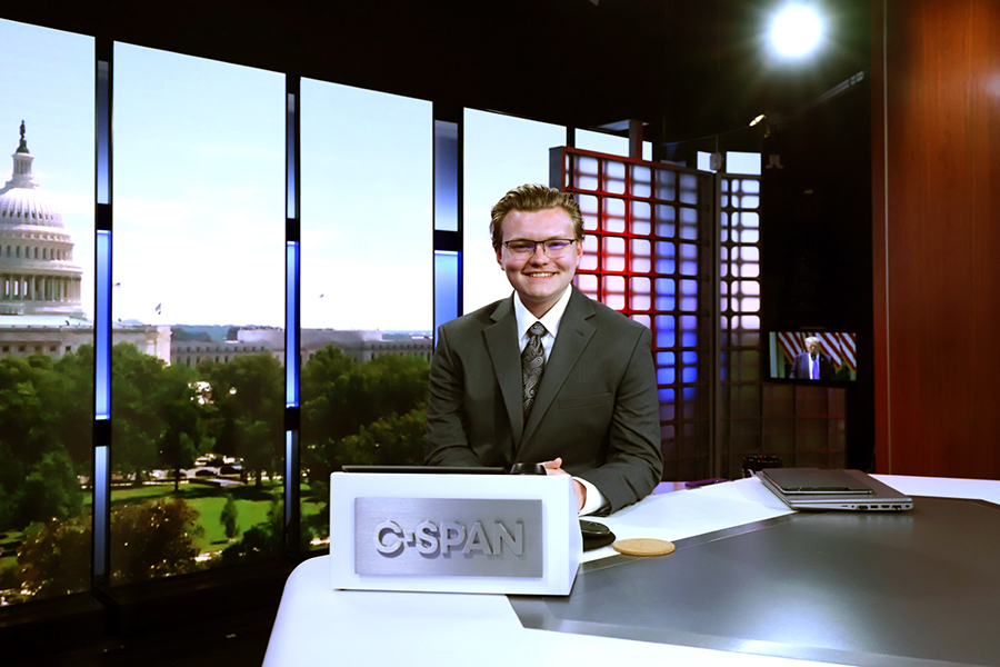 Student with light hair and glases smiling