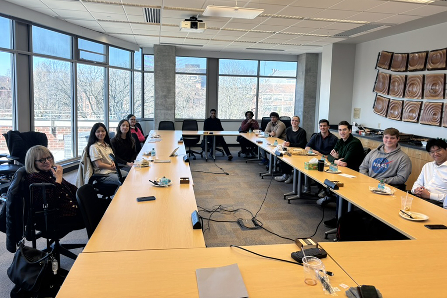 Students sitting around a conference table