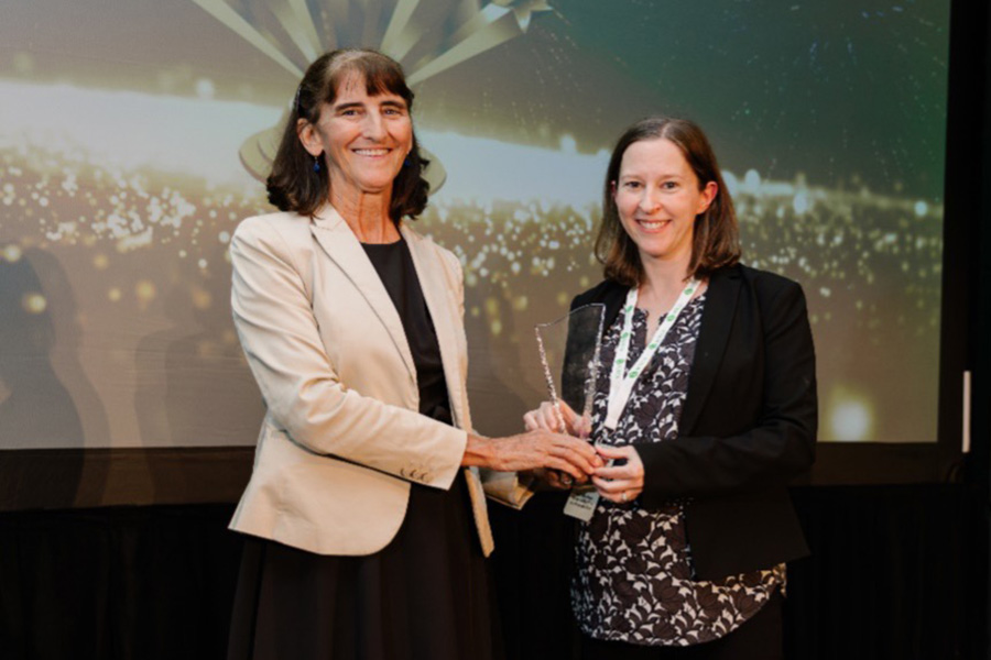 Heather Liddell accepting the award from ACLCA Board Chair Connie Hensler