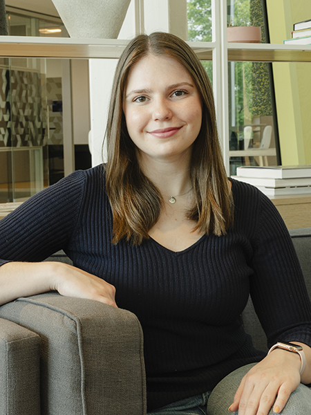 Student with long brown hair, smiling